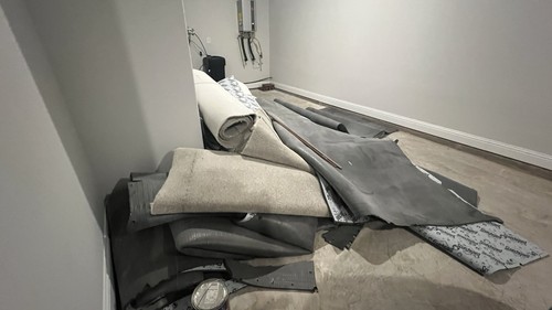 Used carpet pieces — recently replaced with wood tiles