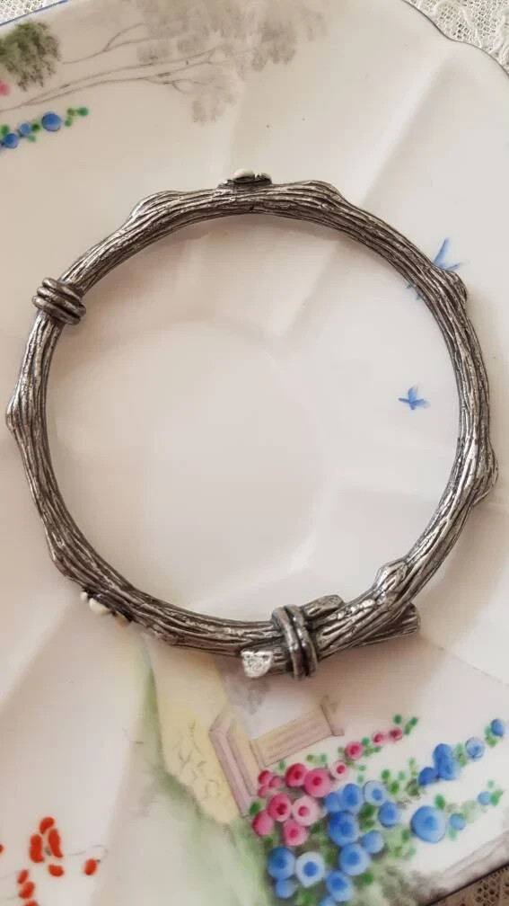 Mimco signed silver-tone bangle with white enamel twig and floral detailing-image