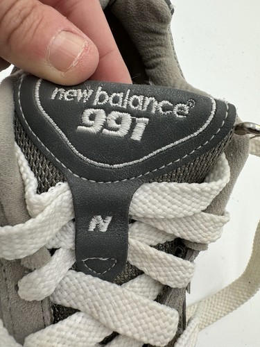 Grey New Balance 991 size 7 with white laces, dark grey collar, and silver “new balance 991” text on tongue.