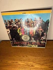 The Beatles Sgt. Peppers Lonely Hearts Club Band Vinyl Record Album with cutouts