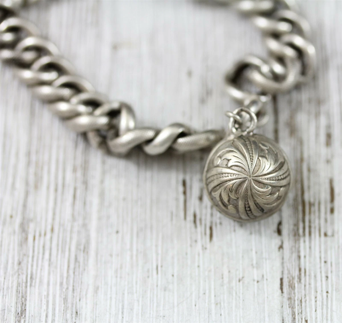 Silver bracelet with shop balls on end