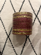 Beautiful pink bangles, unworn and still in plastic wrapping, with gold details