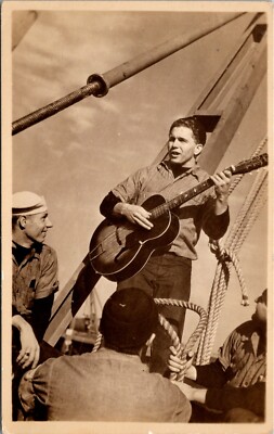 Man with With Guitar Plays and Sings Song On Board a Ship RPPC Postcard    16522