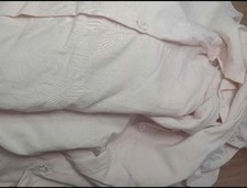 Light pink twin duvet cover with pillow sham. Ruffled edges and button close