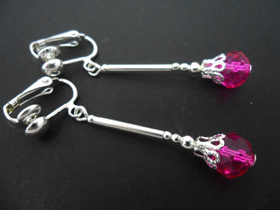 A PAIR OF DANGLY BRIGHT PINK CRYSTAL BEAD SILVER PLATED DROP CLIP ON EARRINGS. - Image 1 of 1