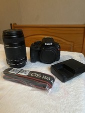 Canon EOS Rebel SL1 with 55-250 canon lens, Camera charger and camera strap.