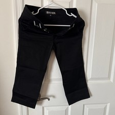 Comfortable black capri pants with button details.
