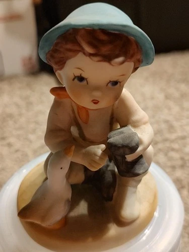 vintage porcelain figurine of a boy and his duck