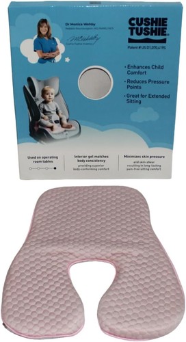 Pink gel polymer and memory foam cushion with circular opening, shown on packaging and labeled “CUSHIE TUSHIE” in white.