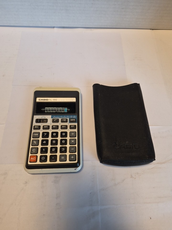 A vintage Casio AL-8S calculator with its original soft case — pre-scientific-calculator elegance in a collectible retro package.
