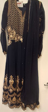 Blue anarkali gown with heavy gold embroidery and matching dupatta.