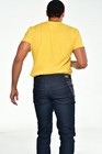 Man wearing blue denim bootcut jeans size 40x33 with yellow back patch and black “BU” logo on waistband.