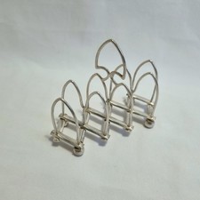 Antique expanding silver plated Gothic arch toast rack for four slices.