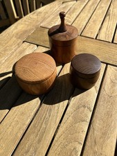 A Set of Three Turned Wooden Pots with Lids
