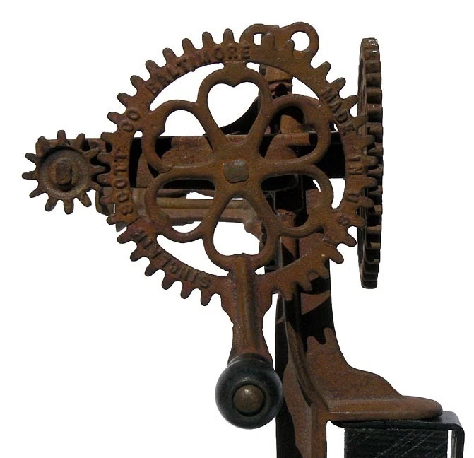 Wonderful looking, old metal apple peeler. Hearts are cast in two large gears.