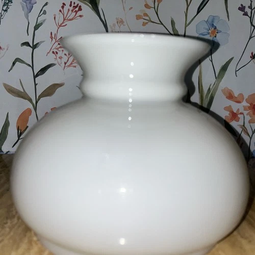 A vintage white milk glass globe lamp shade with a flared rim.