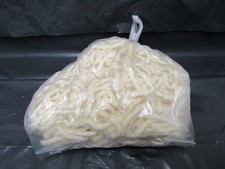 A bag of Latch Hook Yarn cut for rug making cream colour with hook
