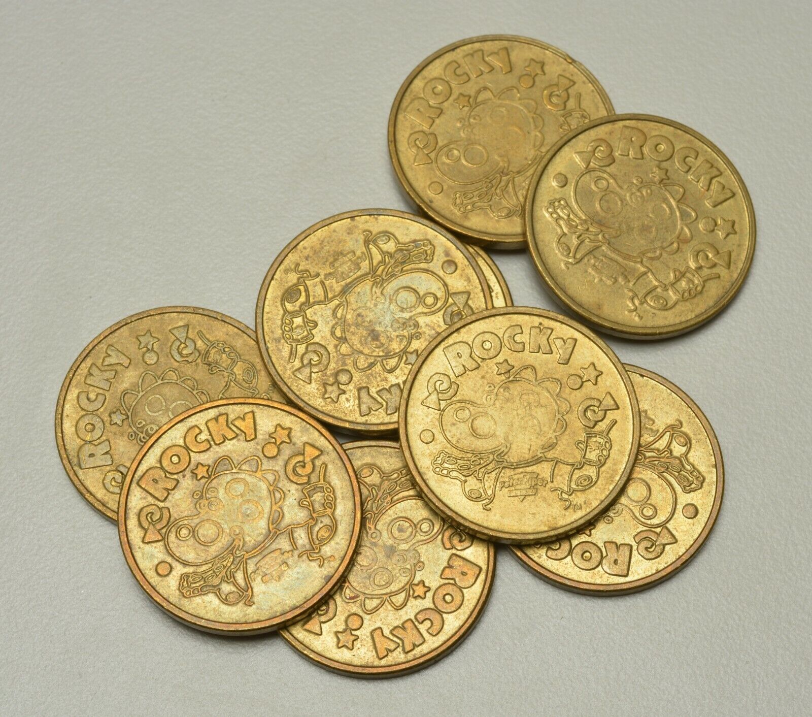 ND. USA. Peter Piper Pizza Tokens. Lot of 9. Brass.