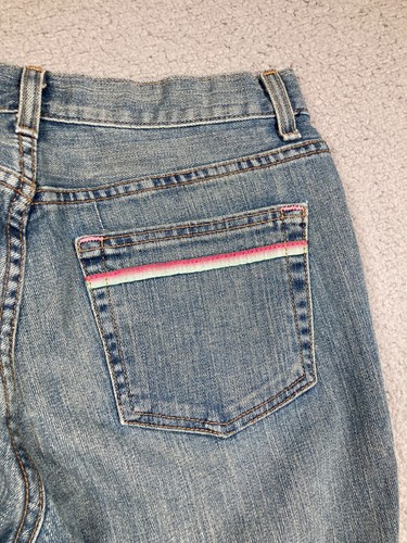 Blue Karen Kane Lifestyle jeans back pocket with pink and red stripe detail and “USA Made” text on waistband.