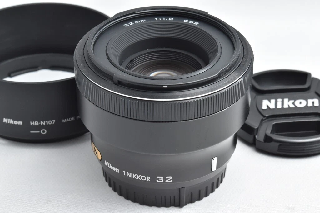Preços baixos em 32mm Nikon 1 NIKKOR Focal lentes de câmera de f