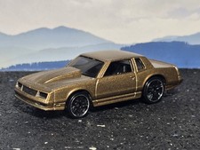 Hot Wheels customized Monte Carlo in gold, original wheels, rolls good