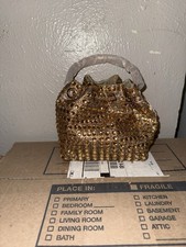 This is a gold rhinestone bucket-style evening bag with a chain strap