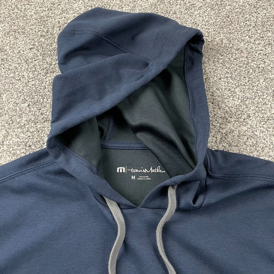 Sudadera con Capucha Travis Mathew Hombres Mediana Azul Logo Pullover Sudadera con Capucha Informal Golf Foto 3 de 4
