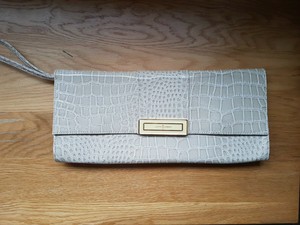 cream patent clutch bag