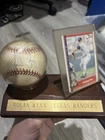 Nolan Ryan Autographed Baseball In Plastic Case And Wooden Stand