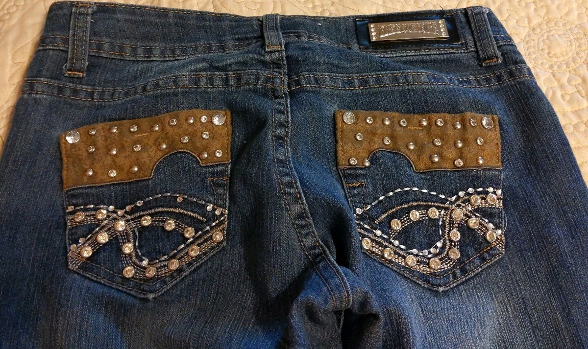 Free Culture skinny medium wash jeans with rhinestone emblishments