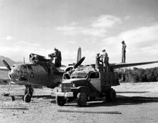 Soldiers pouring special tank A 20 plane insecticide will be spray- WWII Photo