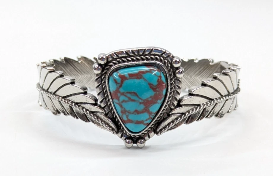 Brazalete grueso tono plata pluma imitación turquesa bisagras Foto 2 de 4