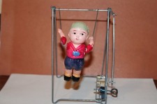 CELLULOID BOY ACROBAT ON TRAPEZE MECHANICAL WIND UP