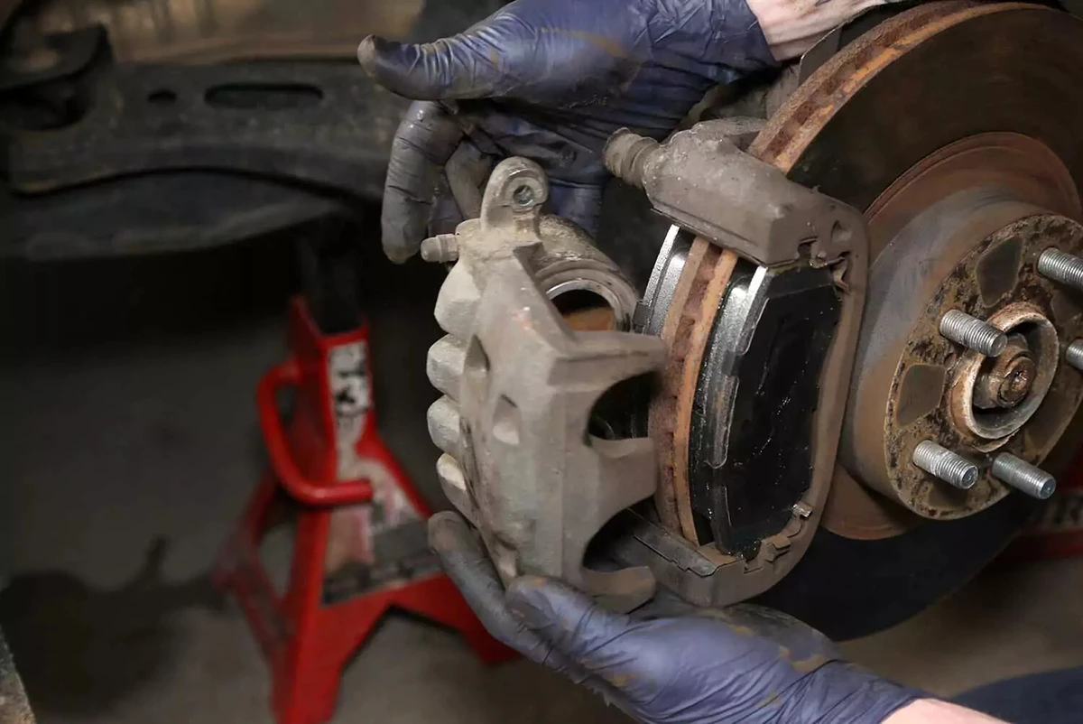 Installing a brake caliper onto a rotor.