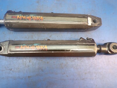 OMC King Cobra Trim Ram pair with part number 985660 (LOC-BD