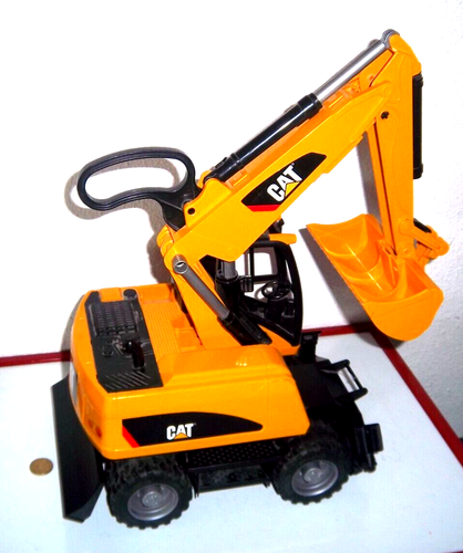 BRUDER 1517 - PELLE / EXCAVATRICE SUR ROUES CAT / CATERPILLAR  - TRES BON ETAT - Foto 1 di 6