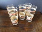 SET OF SIX CLEAR DRINKING GLASSES WITH PINECONE DESIGN ON THEM AND PLAID BAND