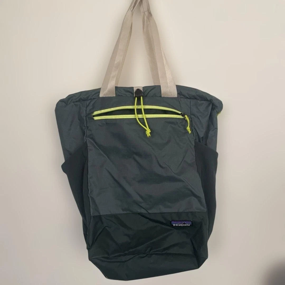 patagonia borealis green ultralight black hole tote pack small interior stash pocket Folded webbing handles for a comfortable carry Tote volume is 25 litres Made in a Fair Trade Certified factory Patagonia Recycled Ultralight Black Hole