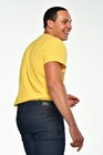 Man wearing yellow short-sleeve shirt with black denim bootcut jeans, size 40x33, and black belt loops.