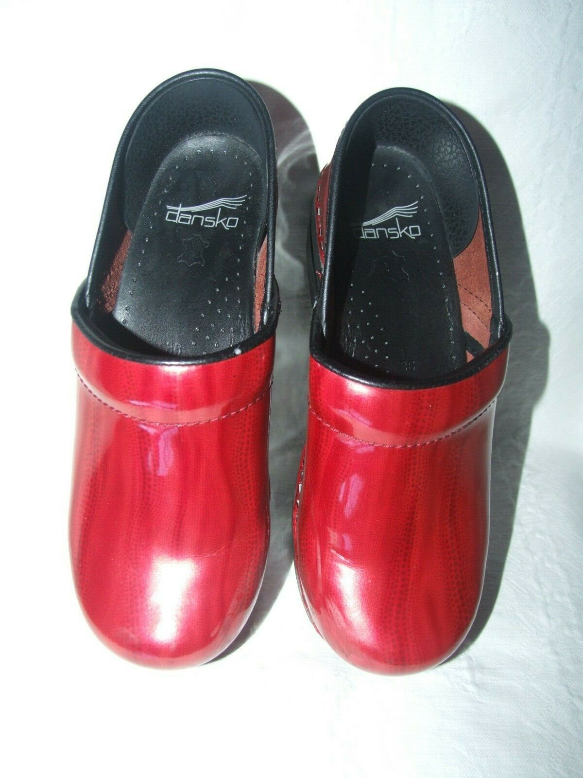 dansko red patent leather clogs