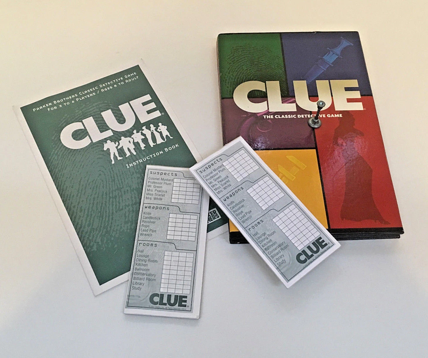 Clue board game pieces rope candlestick game board notebook instructions