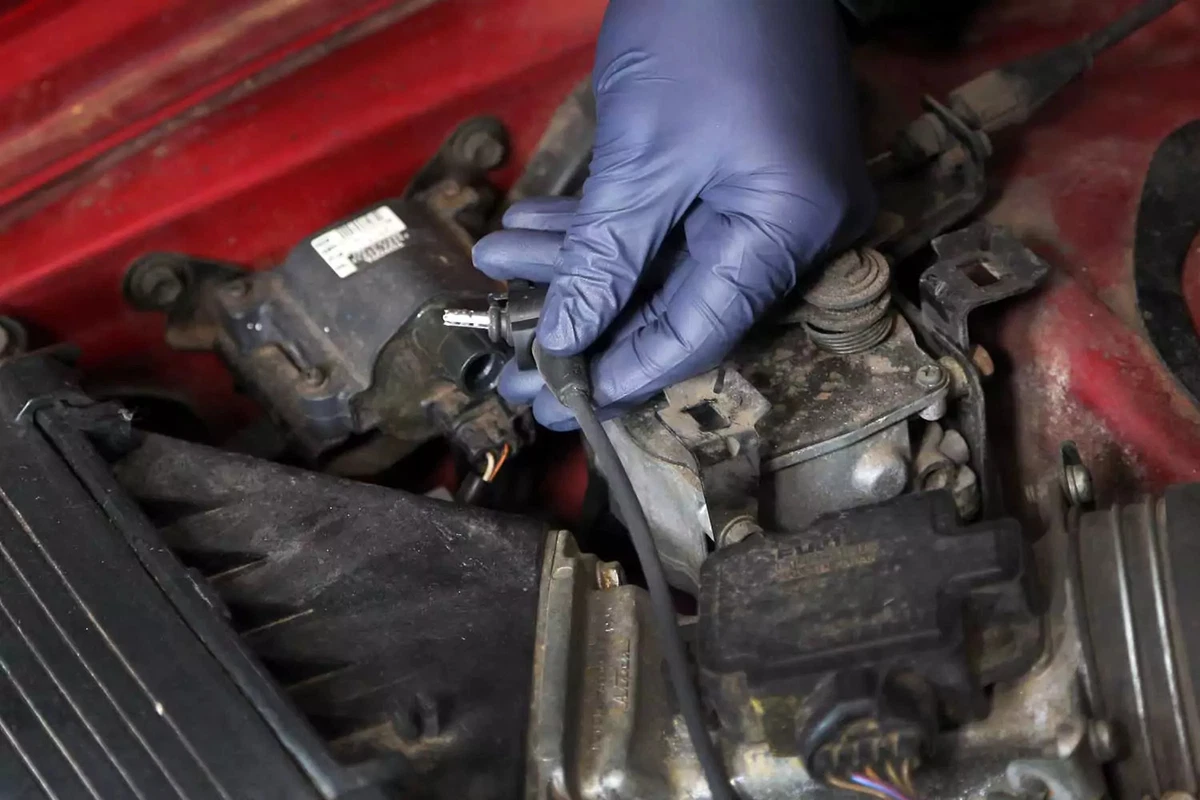 Holding an ignition wire.