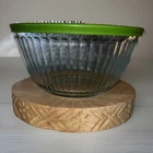 vintage-style glass bowl is a Pyrex Sculpted 6-Cup Mixing Bowl With Green Lid