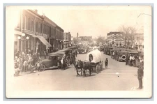 NORTON KANSAS RPPC ~ Street view side of Square ~ 4th of July Parade