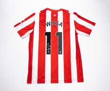 Yoane Wissa Signed & Framed Brentford F.C. Shirt Genuine Signature AFTAL COA Yoane Wissa Signed & Framed Brentford F.C. Shirt Genuine Signature AFTAL COA