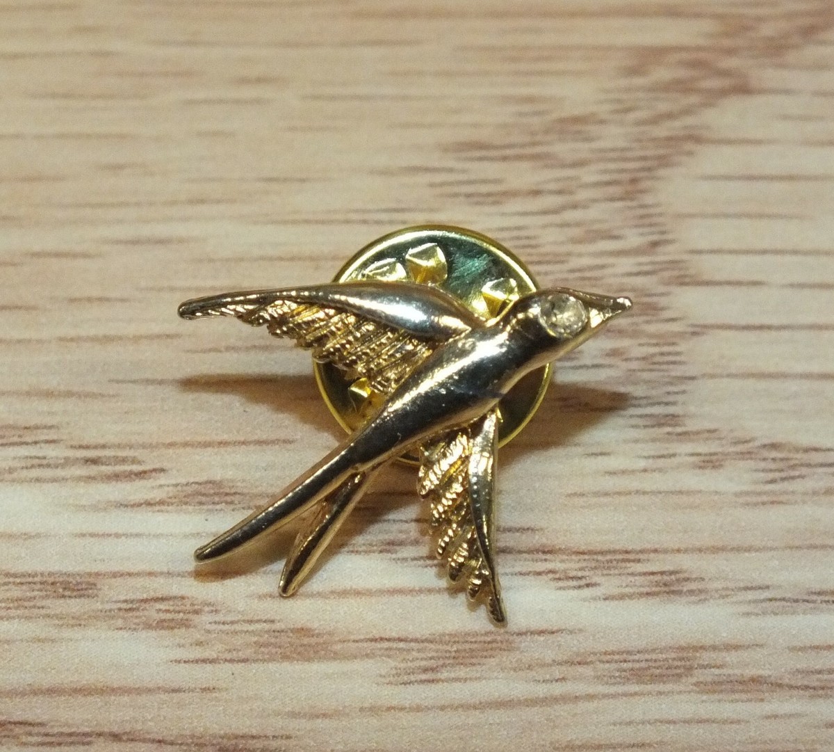 Gold bird pin discount