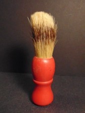 Older shaving brush with red wood handle