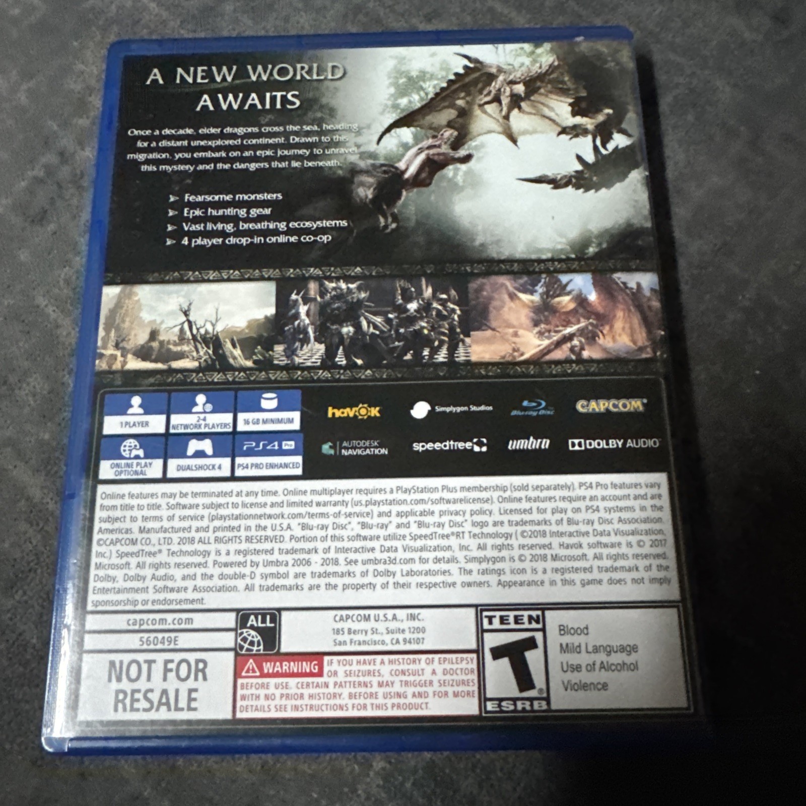 Monster Hunter: World PS4 case with back cover art, yellow dragon silhouette, and Capcom logos.