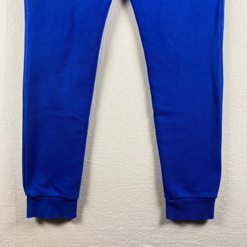 Pantalones deportivos Adidas para hombre pequeños azules Essentials Primegreen Trifoil para correr - Imagen 9 de 13