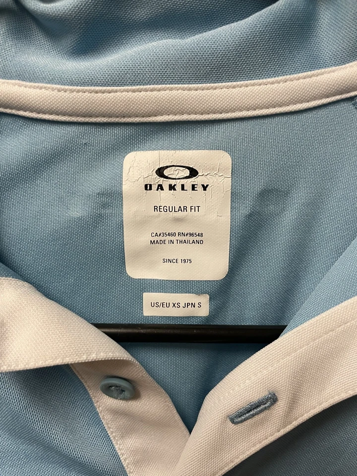 Polo de manga corta Oakley azul claro/blanco para dama - talla XS Foto 2 de 3